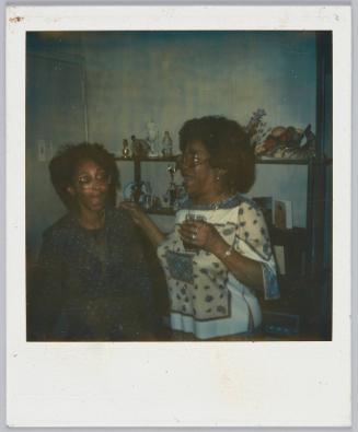 [Two women with big hair and wide rimmed glasses with their mouths open]