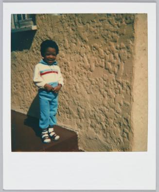 3-15-82 3 years old [Three year old boy standing on step with big grin]