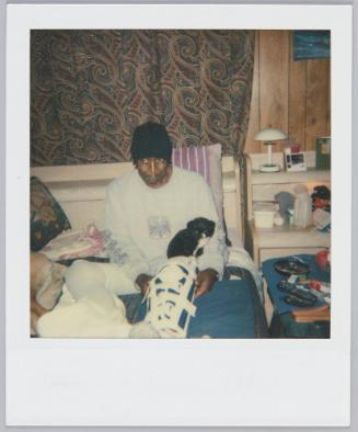 [Elderly man with broken leg sitting in bed]