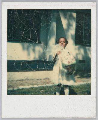 [Little girl in white dress holding an Easter basket]
