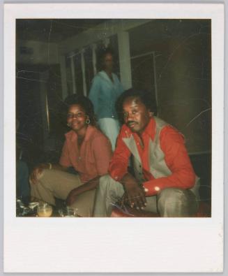 [Man and woman both leaning forward while seated]