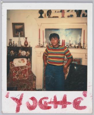 'Yoche' [Young woman wearing striped tshirt posing in front of mantle]