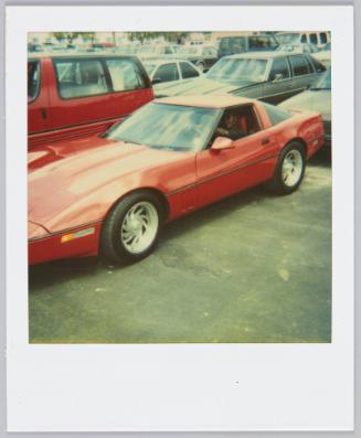 [Red sports car, man in driver's seat]