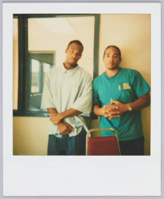 [Two young men posing, young man on right wearing green tshirt]