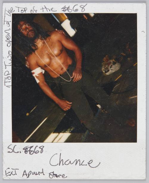 SC. 68 Chance Ext [illeg.] Store [Shirtless man wearing black pinstriped pants and a bandage around his arm]