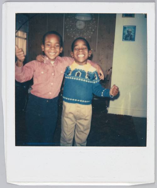 [Two little boy arm-in-arm smiling big]