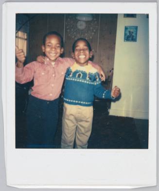 [Two little boy arm-in-arm smiling big]