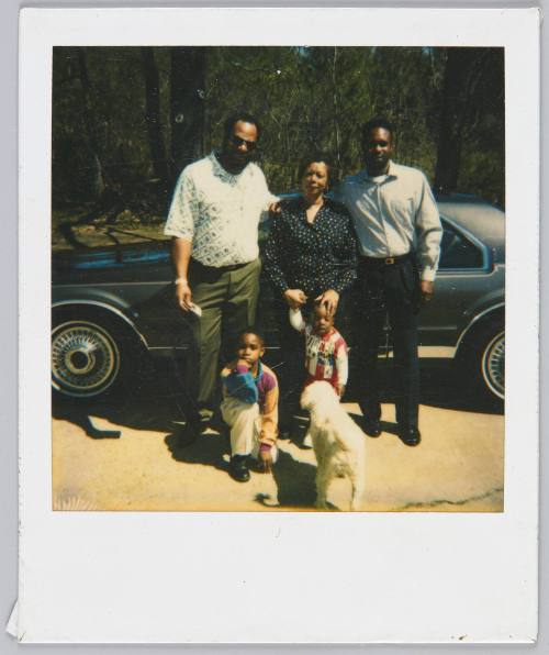 3-14-94 [Family standing in front of car, white dog standing in front of children]
