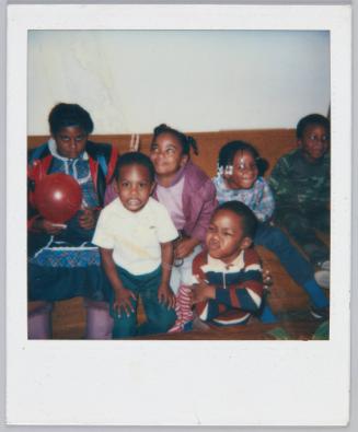 [Group of little kids sitting on a couch, making funny faces]