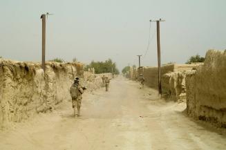 US Marines from the 24th Marine Expeditionary Unit (MEU) Battle Landing Team (BLT) 1/6 Alpha Company patrol down a main street of a village in Garmsir District, Helmand Province, Afghanistan. Garmsir has been a haven for insurgents for the last several years. Earlier this year the Marines cleared the area after a period of heavy fighting and recently handed over control to British Forces