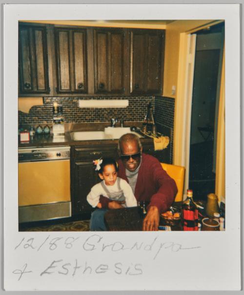 12/88 Grandpa + Esthesis [Man in tinted glasses sitting at kitchen table with a girl in overalls on his lap]