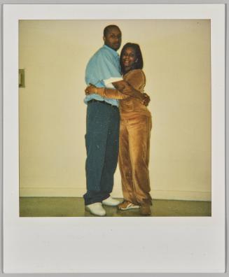 Ant + Michelle 3.9.03 [Woman in velour tracksuit hugging man in blue short-sleeved shirt]
