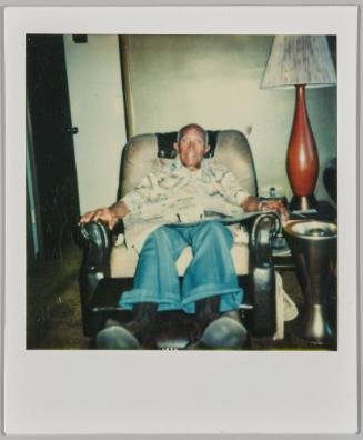 [Elderly man sitting in reclining chair]