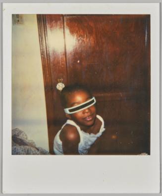 [Girl wearing costume sunglasses in front of wooden door]
