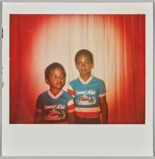 [Two young boys wearing matching shirts that have writing "Smart Kids"]

