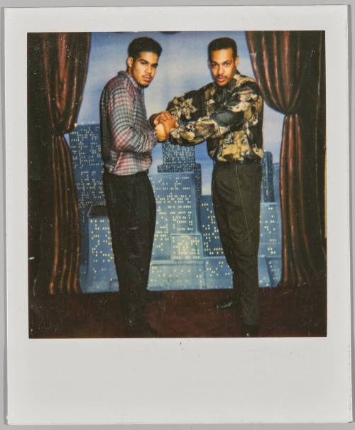 [Two young men posing, grabbing each other’s fists]
