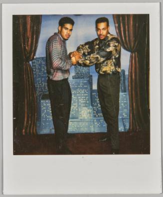 [Two young men posing, grabbing each other’s fists]
