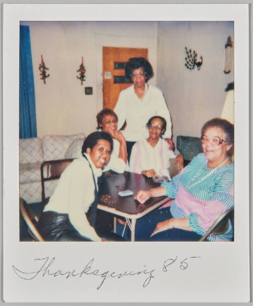 Thanksgiving '85 [Five women seated around coffee table playing card game]
