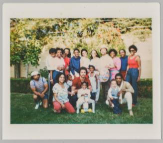 [Large group posing in backyard]
