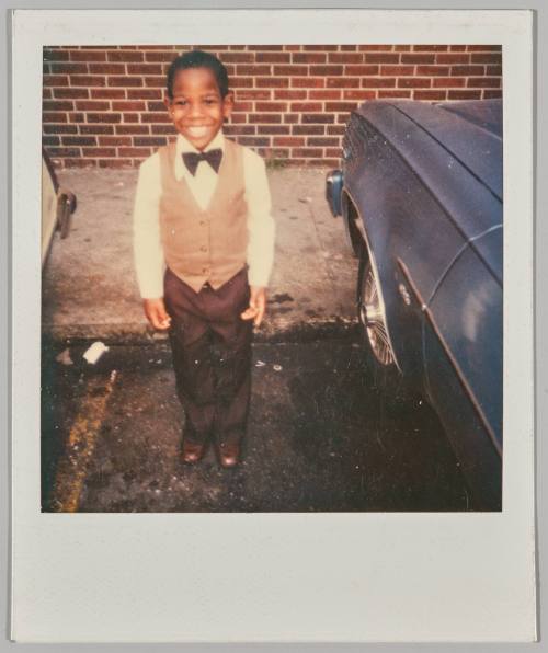 [Little boy wearing bowtie posing]
