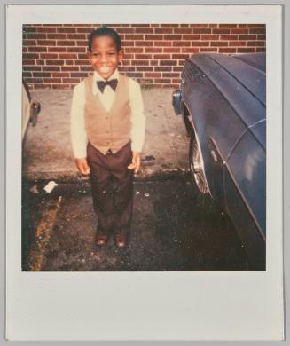 [Little boy wearing bowtie posing]
