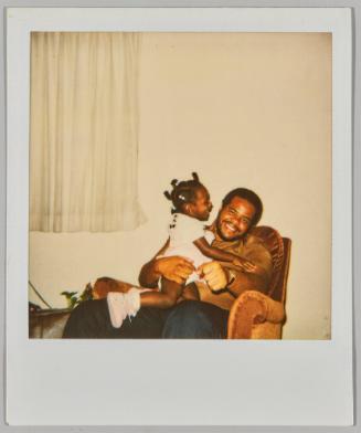 [Man sitting with little girl on lap]
