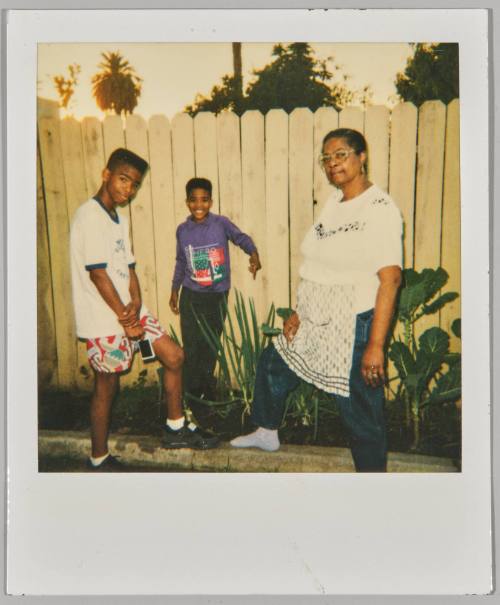 [Older woman posing in garden with young boys]
