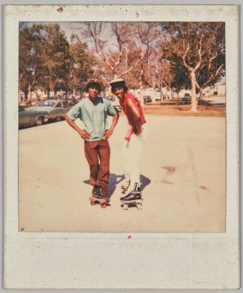 [Two young men posing on rollerskates]
