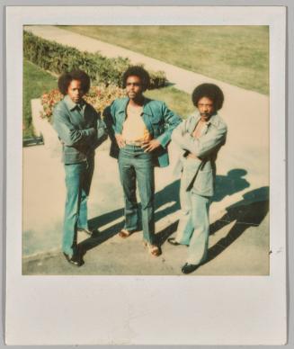 [Three men in denim and afros posing]
