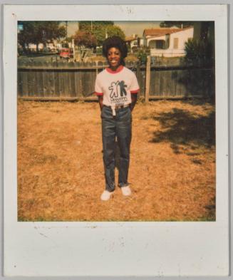 [Woman posing in front yard wearing "LAWATT'S" t-shirt]
