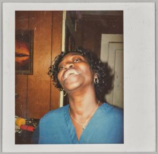 [Woman smiling with head tilted back wearing silver jewellery]
