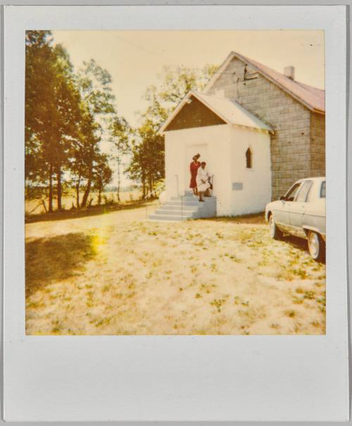 [Two women on staircase of church]
