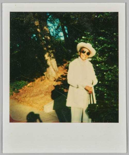 "12-9-79" (after) To Sis. [Araminta?] [Woman dressed in white in sunhat and sunglasses in greenspace]