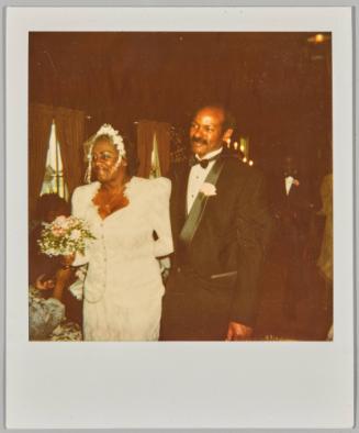 [Bride and groom smiling, bride wearing white floral veil]
