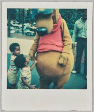 Aug, 27, 1978 [Two toddlers holding dog mascot's hand]