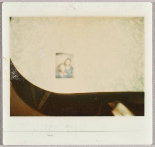 [Photograph of two people on table]
