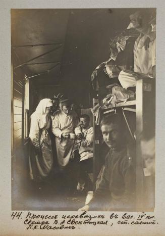 Process of bandaging in IV class car.Nurse V.A Svetnitskaya, senior medic P.K Masevich