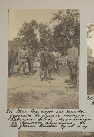 railway worker from Pilva station holding unexploded bomb thrown in Pilva's station building, Privolzhskaya railway.