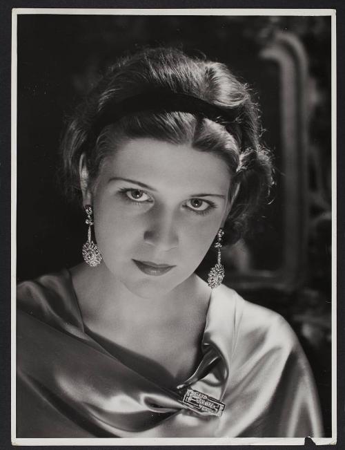 Headshot of woman with big earrings.