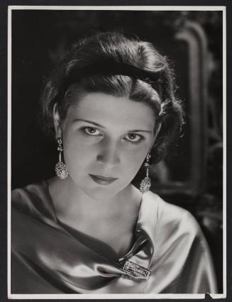Headshot of woman with big earrings.
