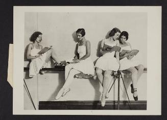 Ballerina's taking time out to read.