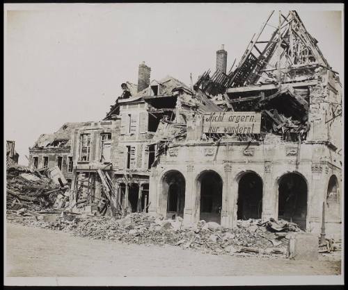 The Fall of Peronne. Wrecked building on the Grande Place, Peronne, showing German notice