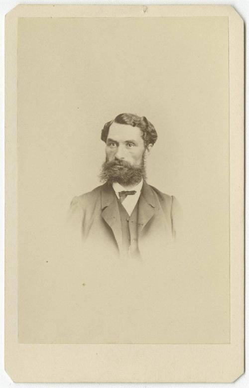 [Young bearded man with buttoned coat]