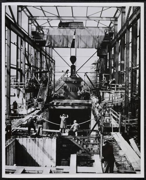 A 165 ton pressure vessel is lowered in to the Shipping port atomic power plant.