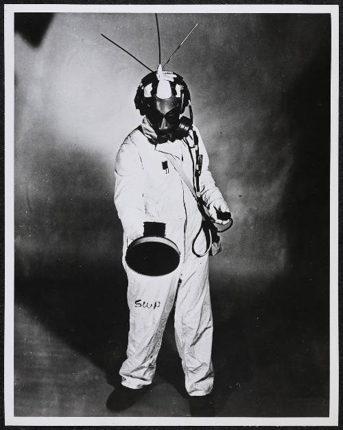 Nuclear worker in suit with Geiger counter
