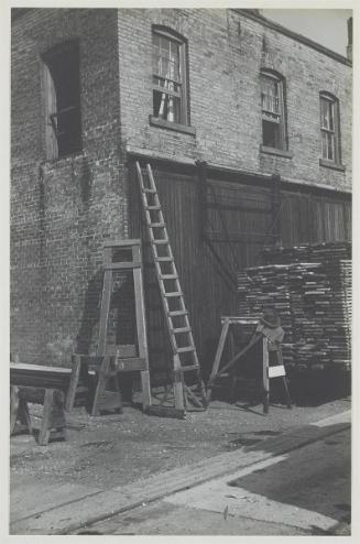 [Ladder Against Brick Building]