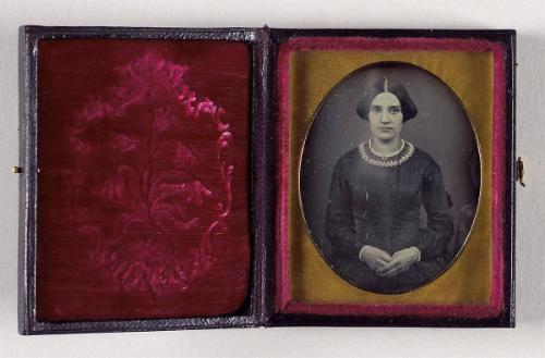 [Portrait of a young woman with folded hands]