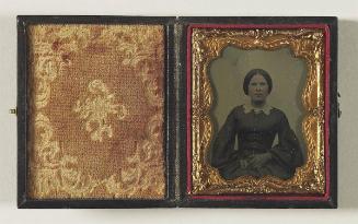 [Portrait of a woman holding a photograph]