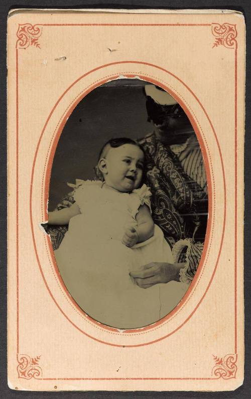 Portrait of Blanche Carney Cotton at 9 months (seated on lap with figure defaced)