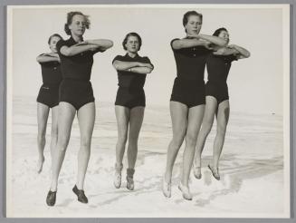 Gymnastics in the snow. A group of women exercise in the snow, not as a pastime, but as physical strength training.